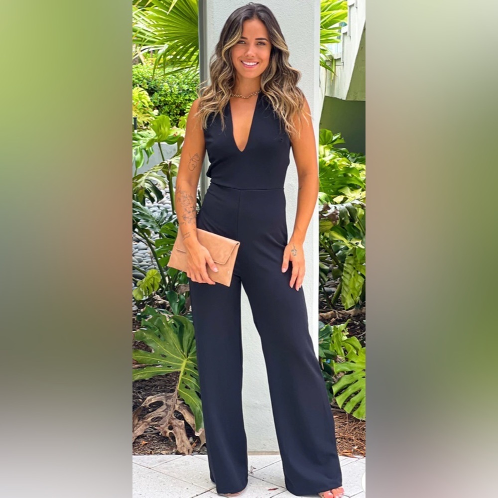 BLACK V-NECK JUMPSUIT WITH CRISS CROSS BACK. Worn once!!